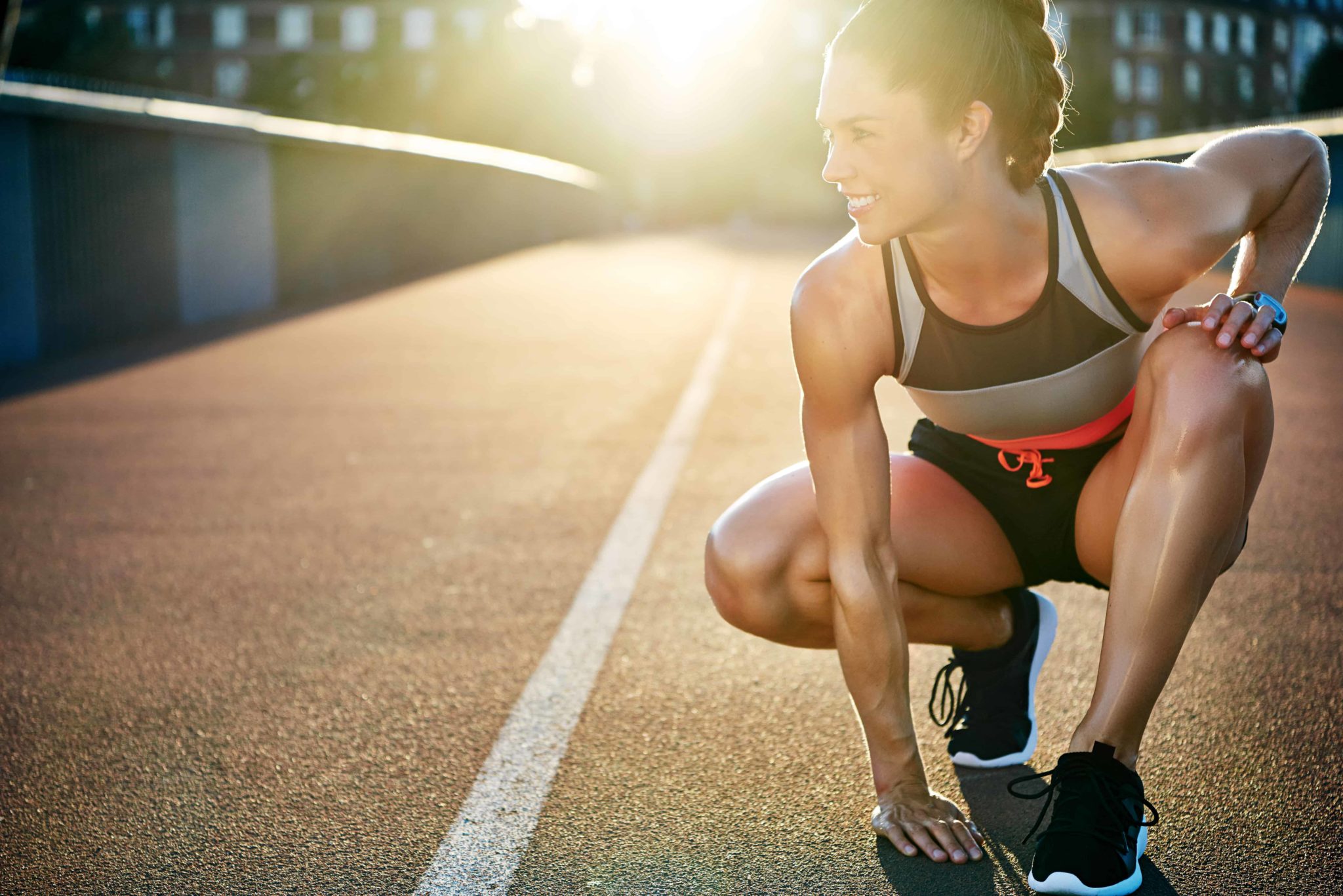 Woman ready to race with palm on floor