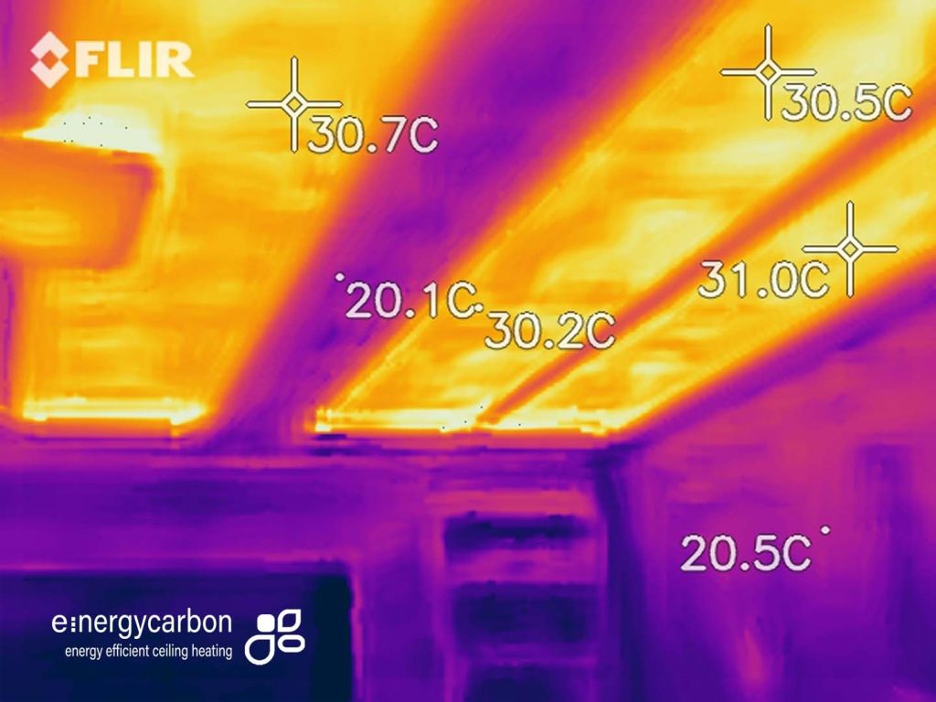 Ultra thin carbon film infrared heating installed behind plasterboard wall shown in architectural cutaway with insulation and heating layer detail.